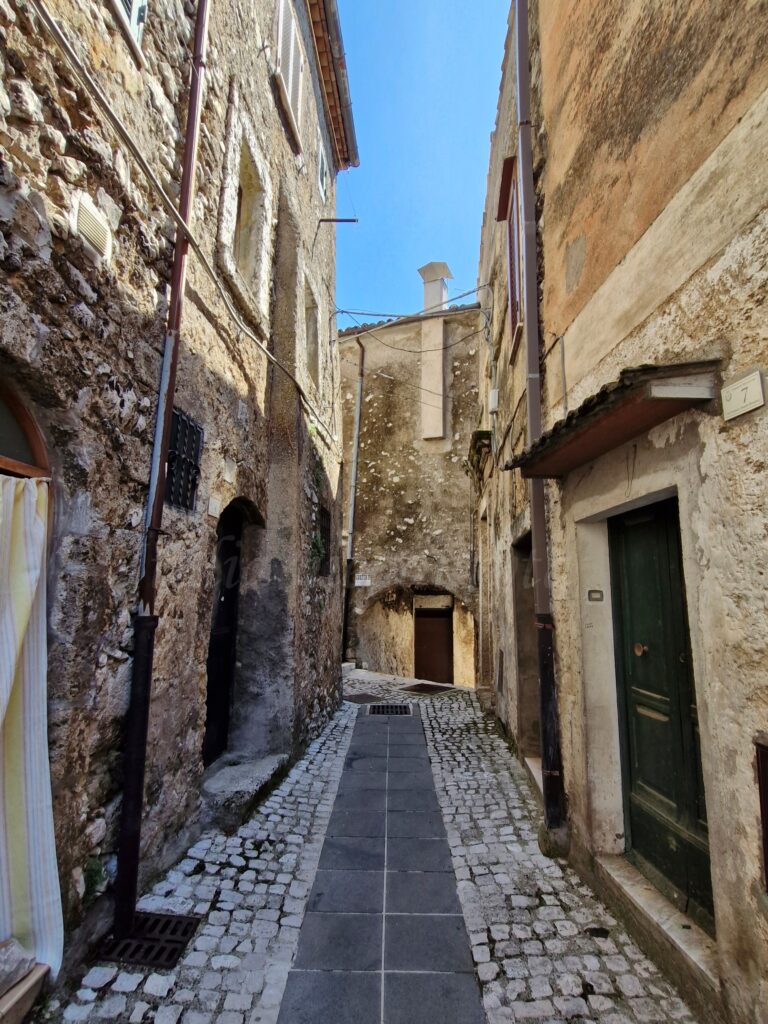 An old stone street between old houses