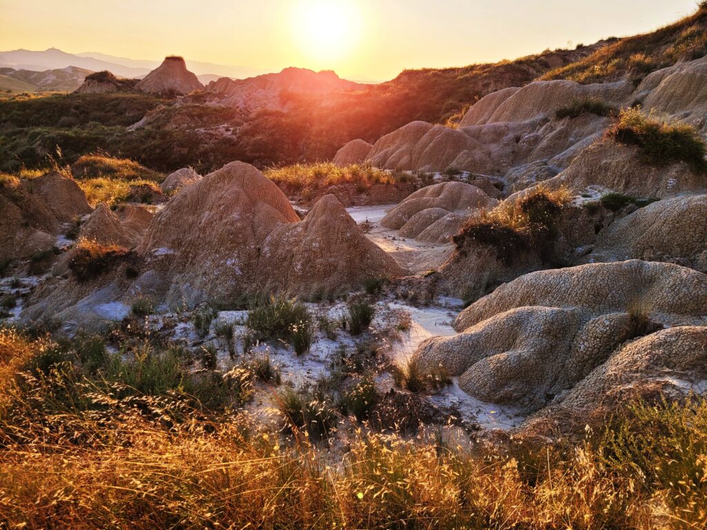 Basilicata badlands The sunset over the Basilicata plateau at Pisici calanchi illuminates the clay hills with a golden glow.