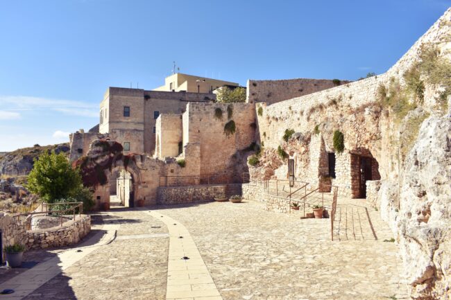 stone courtyard of a medieval light stone building in Pulsano Abbey in Gargano