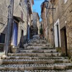 long stone stairs between old stone buildings